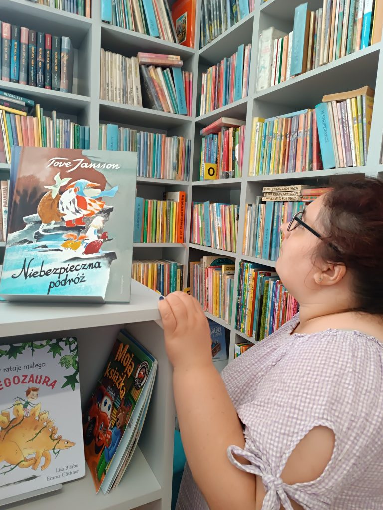 Podopieczni wypożyczają książki w bibliotece