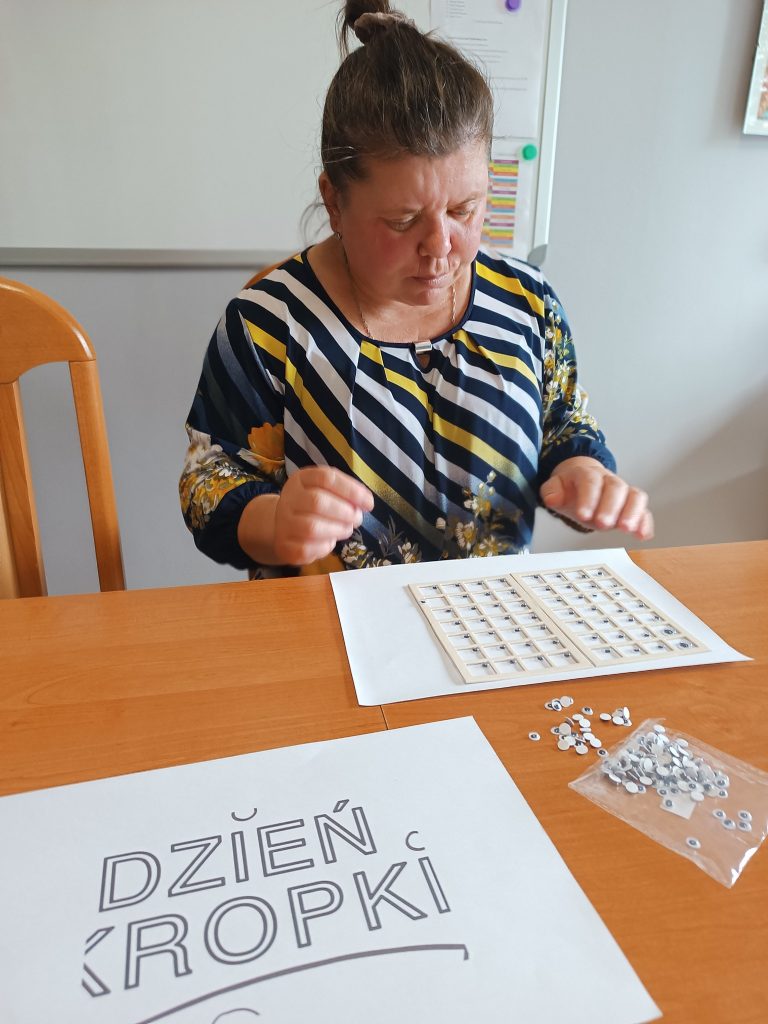 Podopieczna uzupełnia planszę ruchomymi oczkami