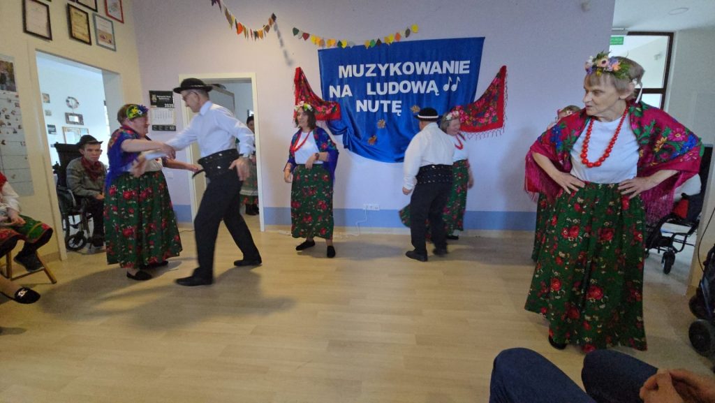 Grupa podopiecznych tańczy w strojach ludowych