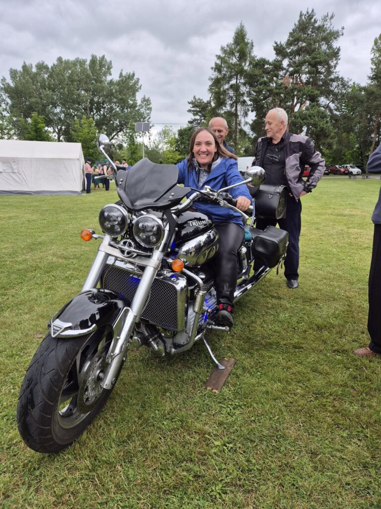 Podopieczna pozuje przy motocyklu
