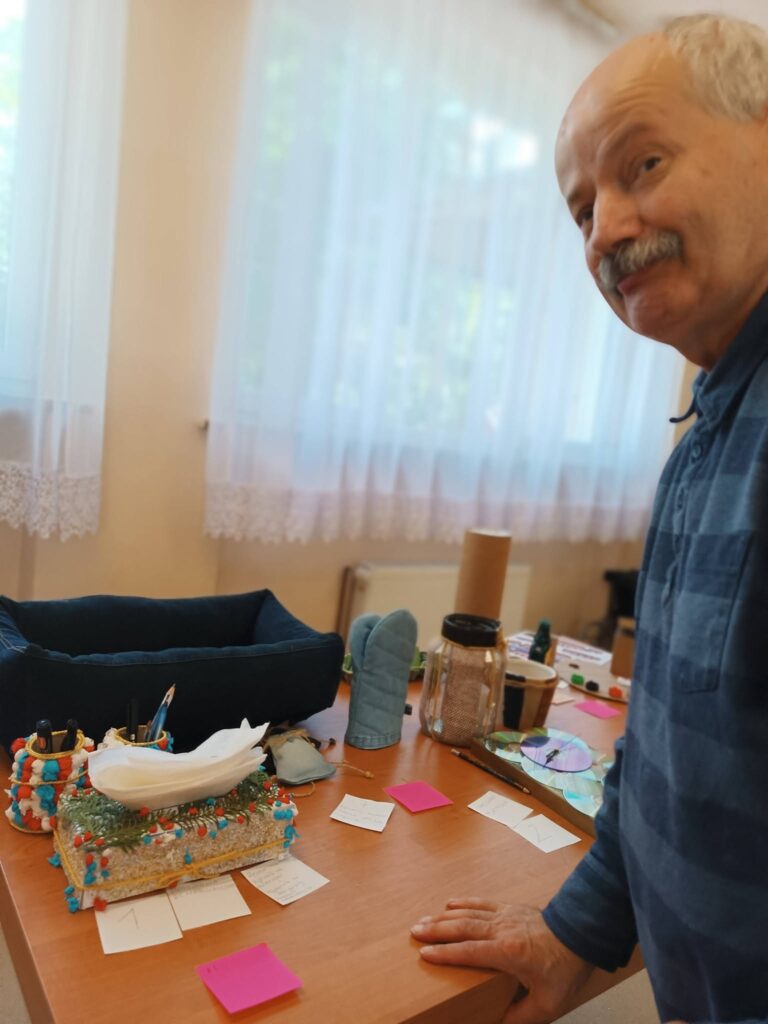 Podopieczny ocenia prace zgłoszone do konkursu recyklingowego